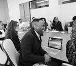 Business professionals engaged in a collaborative meeting in a modern office setting.
