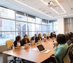 A diverse team of business professionals collaborating in a modern meeting room.